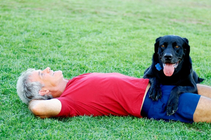 Senior with his black dog